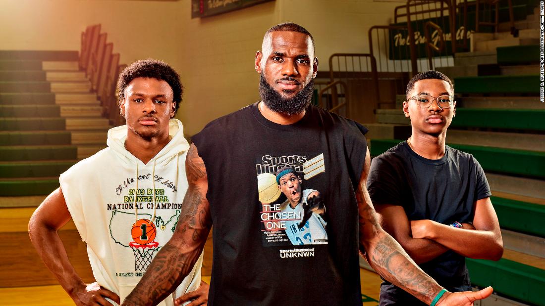 James poses with his two sons — Bronny, left, and Bryce — at his former high school in Akron in July 2022. Bronny was one of the best high school players in the country, and his dad said he wants to finish his career by playing with him in the NBA.