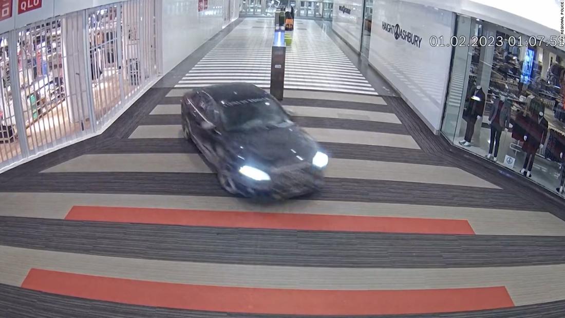 Security footage shows suspects driving stolen car into shopping mall