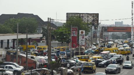 Drivers wait in line to buy fuel at and next to a filling station, causing traffic gridlock on Lagos&#39; Ibadan expressway, in Lagos on January 30, 2023.