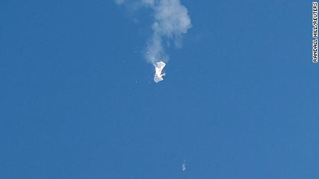 A jet flies by a suspected Chinese spy balloon after shooting it down off the coast in Surfside Beach, South Carolina, U.S. February 4, 2023.  REUTERS/Randall Hill