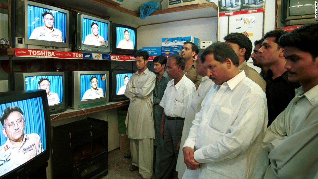 People in Karachi, Pakistan, watch Musharraf address the nation in September 2001. Musharraf said the United States was in the grip of &quot;grief, anger and vengeance&quot; following the 9/11 terrorist attacks.