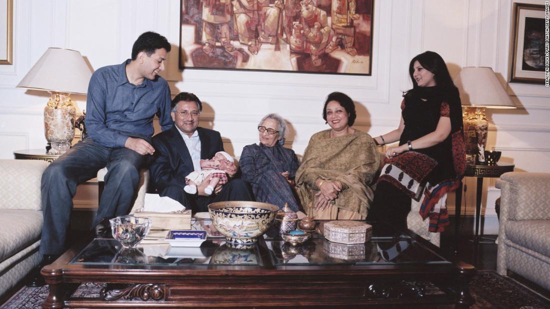 Musharraf holds his grandchild Hamza as he is joined by members of his family in Islamabad in January 2003. Musharraf and his wife, Sehba, had two children, Bilal and Ayla. At center is his mother, Zarin.
