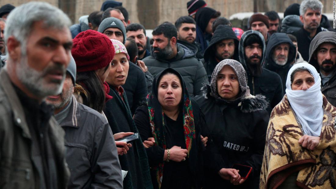 People wait as rescue operations take place in Diyarbakir on February 6.