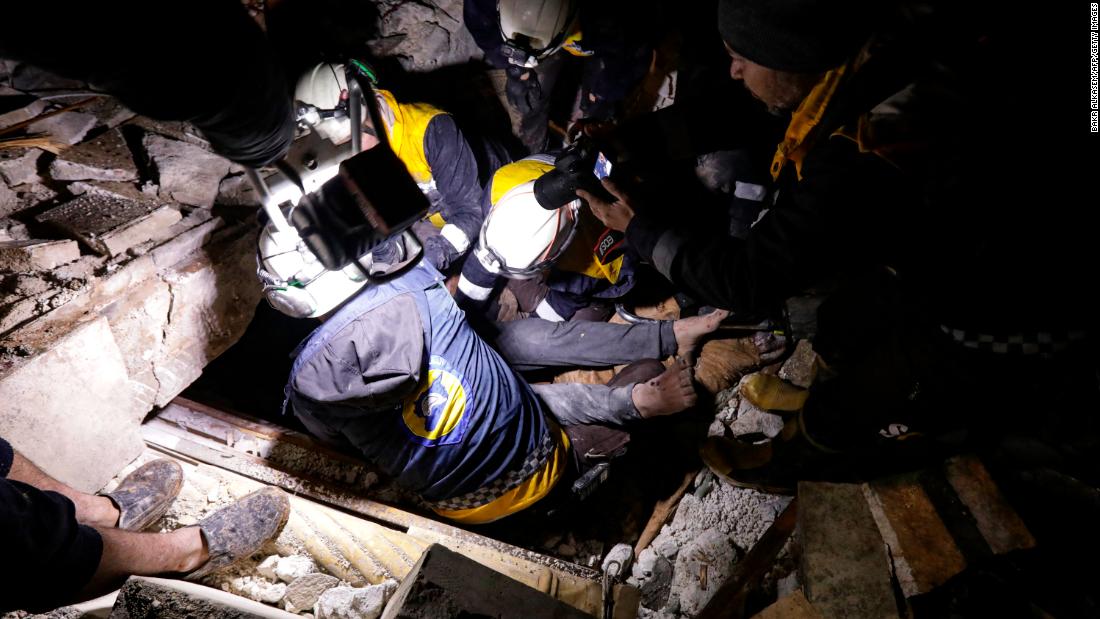 Members of the Syria Civil Defense, aka the White Helmets, retrieve an injured man from the rubble of a collapsed building in Azaz, Syria.