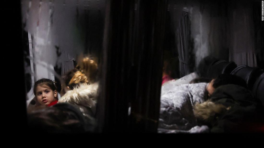 A child looks out from a bus where people were sleeping in Antakya on February 6.