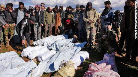 Syrians mourn over people were killed in the village of Hajji Iskandar.