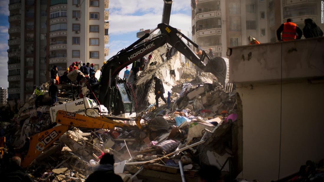 Emergency workers search for people in a destroyed building in Adana, Turkey, on February 7.