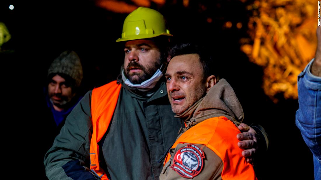 Volunteers share an emotional moment as they take part in a rescue operation in Hatay on February 8.