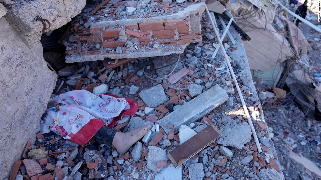 The foot of a dead child is seen under a destroyed building in Kahramanmaras on February 8.