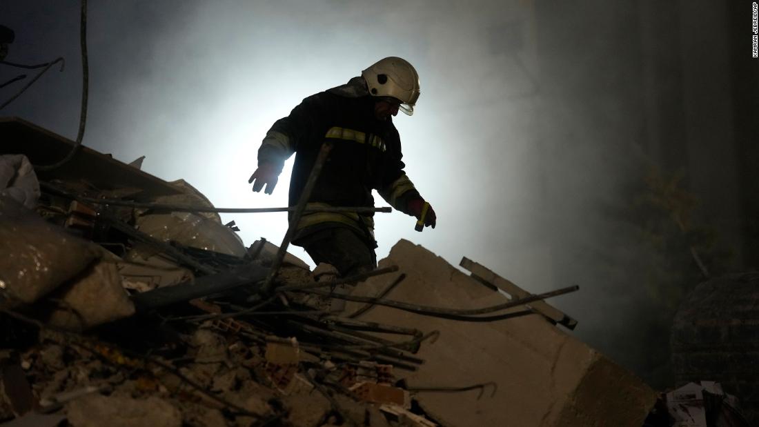 A firefighter searches for people in the rubble of a destroyed building in Gaziantep on February 8.