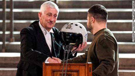 Speaker of the House of Commons  Lindsay Hoyle is presented with a pilot&#39;s helmet by President Zelensky. 