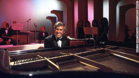 American composer, songwriter, singer and pianist Burt Bacharach performs on his piano circa 1968 in Los Angeles, California. 