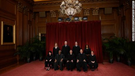 Justices of the US Supreme Court pose for their official photo at the court in Washington, DC, on October 7, 2022.