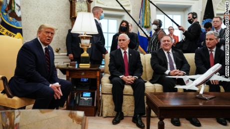 WASHINGTON, DC - AUGUST 20: U.S. President Donald Trump (L) talks to reporters while hosting Iraqi Prime Minister Mustafa Al-Kadhimi and (L-R) Vice President Mike Pence, Secretary of State Mike Pompeo and National Security Advisor Robert O&#39;Brien in the Oval Office at the White House August 20, 2020 in Washington, DC. One day before the meeting, Trump announced that he will allow UN Security Council sanctions to &#39;snap back&#39; into place against Iran, one of Iraq&#39;s neighbors and closest allies, even as U.S. troop levels in Iraq and Syria would most likely shrink in the coming months. (Photo by Anna Moneymaker-Pool/Getty Images)