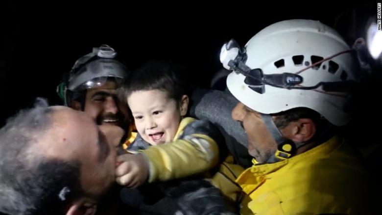 Rescuers celebrate after saving boy from rubble