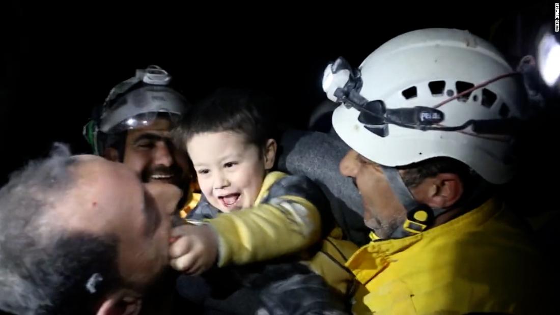 Rescuers celebrate after saving boy from rubble
