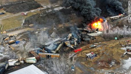 Portions of a Norfolk Southern freight train that derailed February 3 were still on fire the next day.