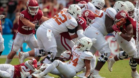 Texas Longhorns running back Jonathon Brooks (24) is tripped up during the second half against the Oklahoma Sooners on October 8, 2022, at the Cotton Bowl stadium in Dallas. 