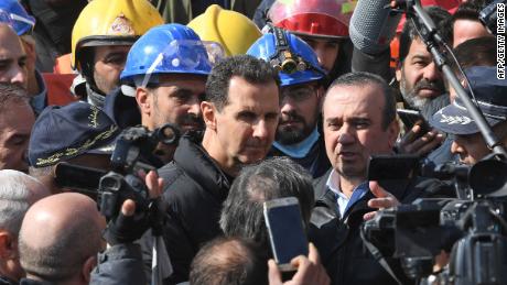 Syrian President Bashar al-Assad (center) visits neighbourhoods affected by an earthquake in the northern city of Aleppo, on February 10. 