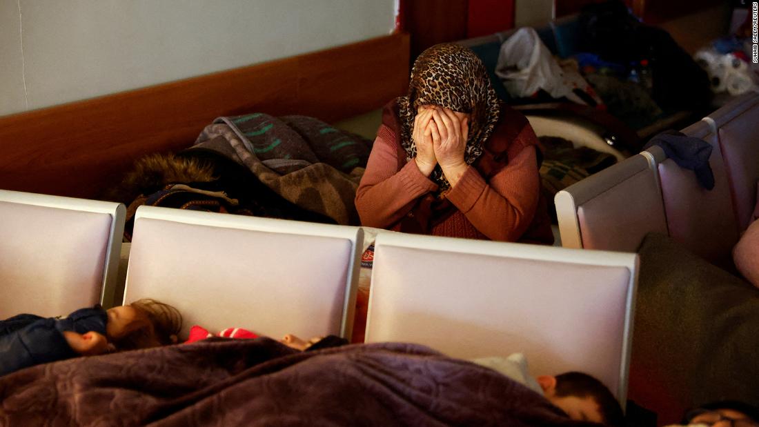 A woman mourns at a hospital in Kahramanmaras while others rest nearby on February 10.