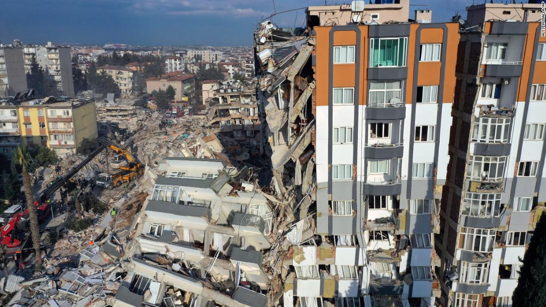 Cranes remove debris next to destroyed buildings in Antakya on February 10. 