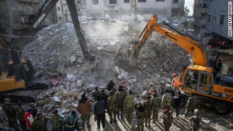 Rescue workers search for survivors in the rubble of a collapsed building in the town of Jableh, in Syria&#39;s northwestern province of Latakia, following a deadly earthquake on February 6, 2023.