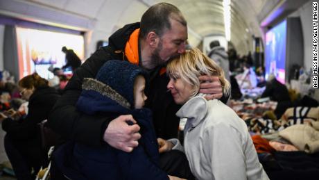 A family takes refuge in a metro station serving as a bomb shelter in Kyiv.