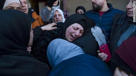 Ghorud Bustami cries while taking the last look at the body of her son Amir Bustami, 21, during his funeral in the West Bank city of Nablus. The Israeli military said the overnight raid was in response to the killing of Ido Baruch in an attack near the settlement of Shavei Shomron in the occupied West Bank on October 11, 2022.
