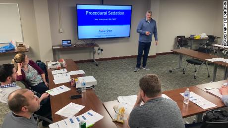 At a two-day company training put on by American Physician Partners in 2020, chief medical officer Dr. Tony Briningstool teaches doctors and nurse practitioners how to safely use sedation in the emergency department. As a money-saving strategy, emergency rooms are employing fewer doctors and relying instead on midlevel practitioners. 