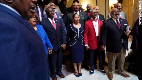 Members of the Mississippi Legislative Black Caucus hold hands and sing &quot;We Shall Overcome&quot; following a news conference where they expressed disappointment at the passage of House Bill 1020.