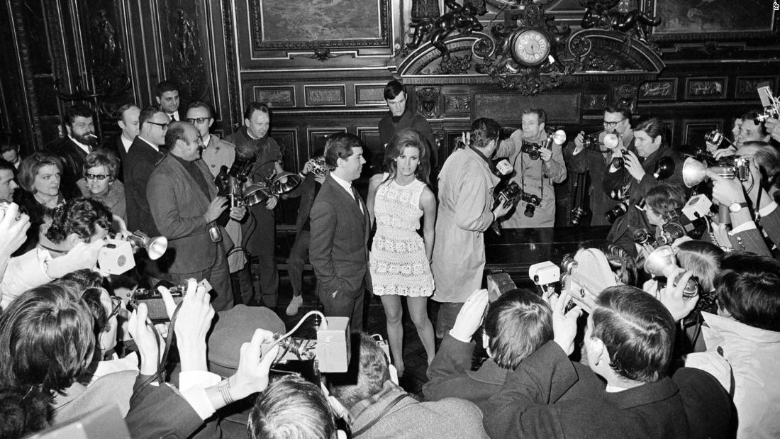 Welch and Curtis are besieged by photographers as they enter a room in Paris for their wedding ceremony in 1967. The ceremony was delayed for 15 minutes while police and city officials tussled with the photographers, who had been ordered out of the room.