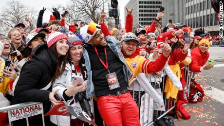 Kansas City Chiefs safety Juan Thornhill celebrates with fans during the parade.