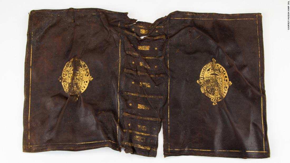 Multiple leather book bindings were found inside a chest, including this calf leather bookbinding with stamp showcasing the coat of arms of the Scottish-English Stuart royal family.