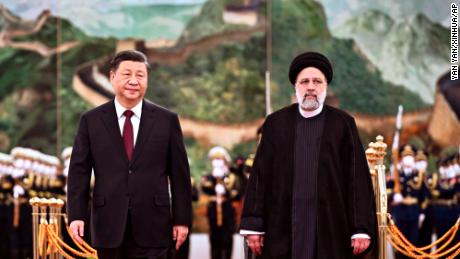 Iranian President Ebrahim Raisi walks with Chinese President Xi Jinping during a welcome ceremony at the Great Hall of the People in Beijing on Tuesday. 