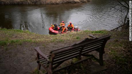 A search dog from Lancashire Police and a crew from Lancashire Fire and Rescue service search the River Wyre near the bench where Bulley&#39;s mobile phone was found, in the village of St Michael&#39;s on Wyre on February 1, 2023.