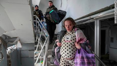 Marianna Vishegirskaya walks downstairs in of a maternity hospital damaged by shelling in Mariupol, Ukraine, Wednesday, March 9, 2022. Vishegirskaya survived the shelling and later delivered a baby girl in another hospital. (AP Photo/Evgeniy Maloletka)