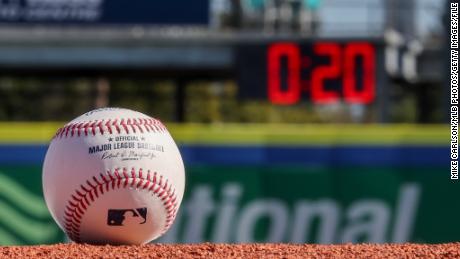 A detail shot of an Official Rawlings baseball on the field with a pitch clock in the background at TD Ballpark on Wednesday, February 15 in Dunedin, Florida.
