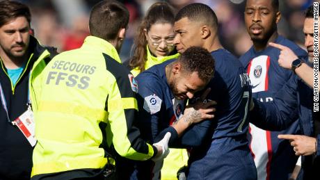 Neymar is comforted by Mbappé before being carried from the field on a stretcher.
