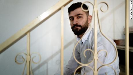 Kayvan Samadi, 23, sits in his safehouse outside Iran, weeks after he was detained for 21 days in a secret detention center. 