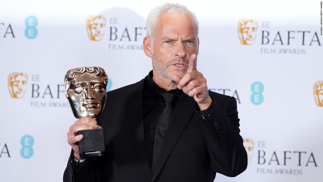 Martin McDonagh poses with his original screenplay award for &quot;The Banshees of Inisherin.&quot;