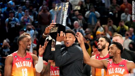 Team captain Giannis Antetokounmpo holds up the winning team trophy after the NBA All-Star game on Sunday night