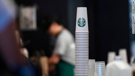 Baristas prepare orders at a Starbucks coffee shop in New York, NY.