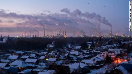 Birds fly above buildings at an oil refinery in the Siberian city of Omsk, Russia, on February 8, 2023. 