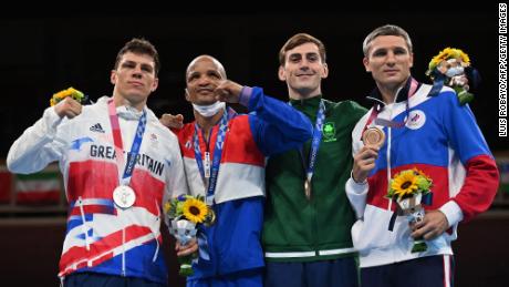 (Left to right) Silver medalist Pat McCormack, gold medalist Cuba&#39;s Roniel Iglesias and bronze medalists Russian Olympic Committee&#39;s Andrei Zamkovoi and Ireland&#39;s Aidan Walsh celebrate on the podium after the men&#39;s welterweight boxing final at the 2020 Olympics. 
