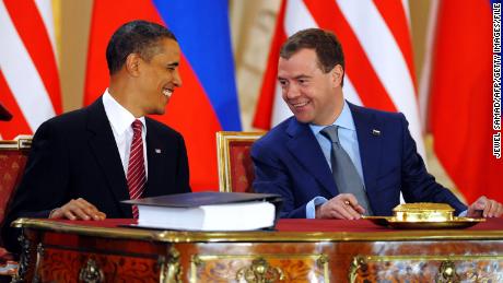 President Barack Obama laughs with his Russian counterpart Dmitry Medvedev as they sign the New START treaty in Prague on April 8, 2010.