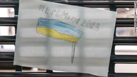 One of Sonya&#39;s drawings shows a Ukrainian flag and says &quot;Victory 2023.&quot;