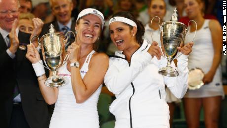 Mirza and Martina Hingis of Switzerland celebrate with the trophy after winning the final of the women&#39;s doubles at Wimbledon in 2015.