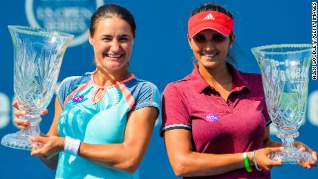 Mirza poses with Monica Niculescu of Romania after defeating Kateryna Bondarenko of the Ukraine and Chia-Jung Chuang of Taipei in the women&#39;s doubles final at the Connecticut Open in 2016.