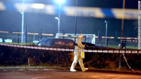 A forensics officer scours the scene where a police officer was shot at a sports complex in Omagh on Wednesday.