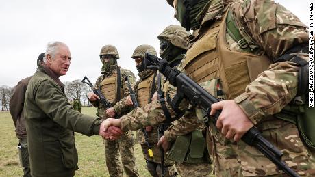 Britain&#39;s King Charles III meets with Ukrainian recruits being trained by British and international partner forces at a site in Wiltshire in southwest England on February 20.